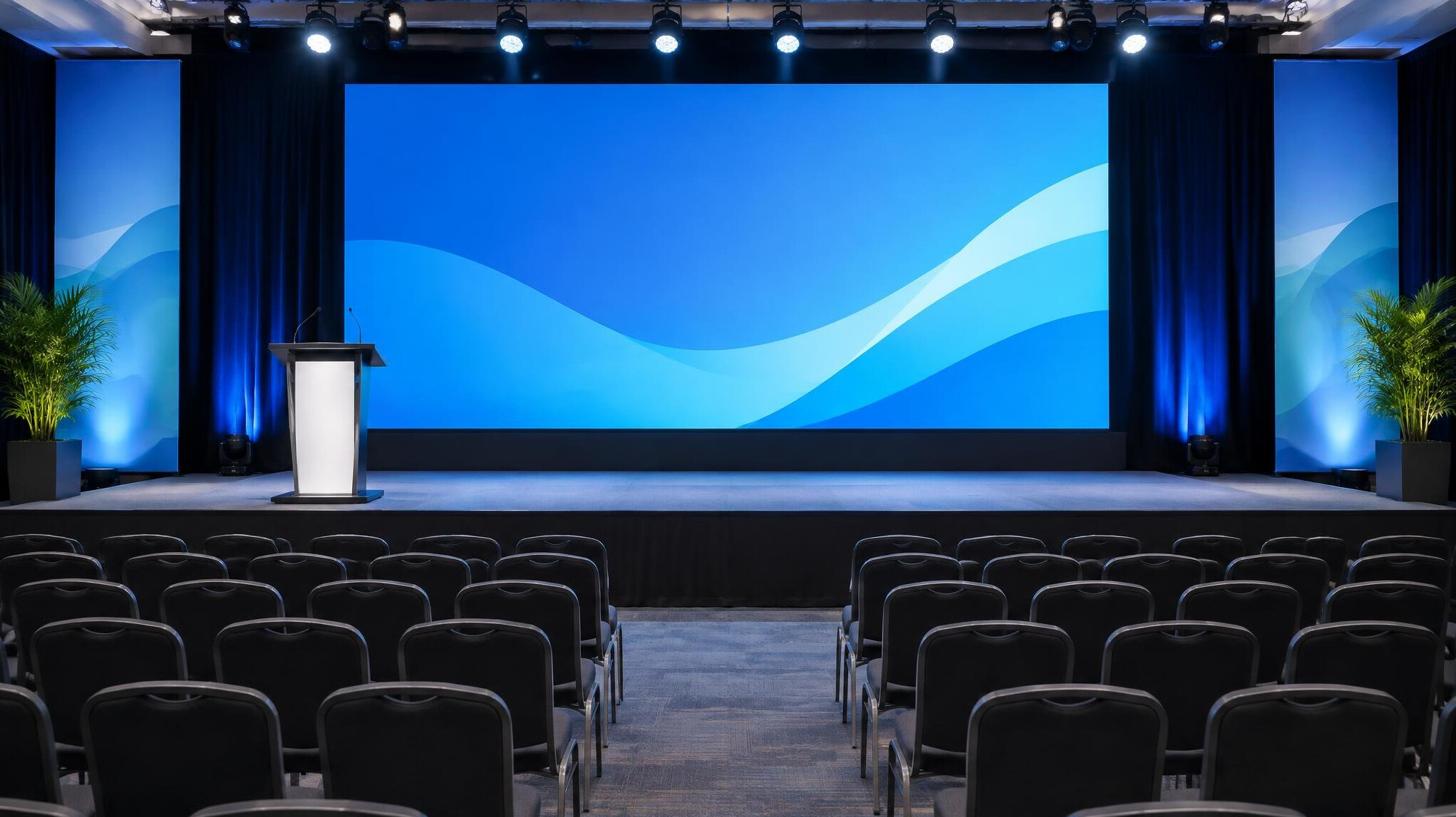Conference stage with large screen and chairs